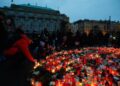 People gather at a memorial during a vigil following a shooting at one of Charles University's buildings in Prague, Czech Republic, December 22, 2023. REUTERS/David W Cerny