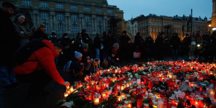 People gather at a memorial during a vigil following a shooting at one of Charles University's buildings in Prague, Czech Republic, December 22, 2023. REUTERS/David W Cerny