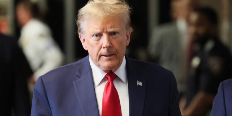 Former U.S. President Donald Trump walks on a hallway on the day of a court hearing on charges of falsifying business records to cover up a hush money payment to a porn star before the 2016 election, in New York State Supreme Court in the Manhattan borough of New York City, U.S., February 15, 2024. REUTERS/Brendan McDermid/File Photo